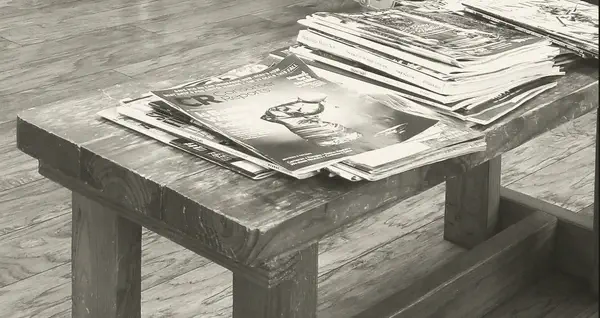 Magazines stacked on the wooden waiting bench