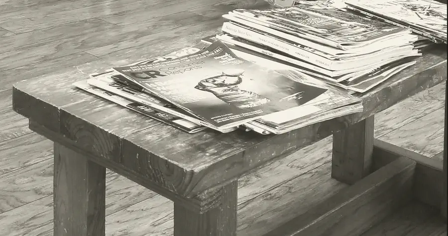 Magazines stacked on the wooden waiting bench